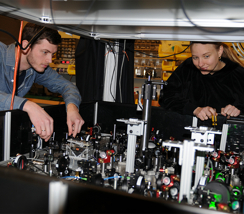 Two students working in a physics lab.