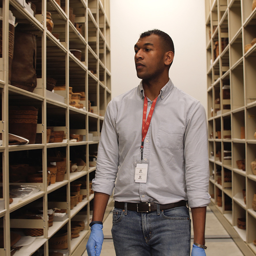 A student walks through the collections at the Burke Museum.