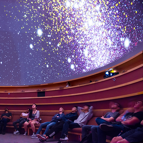 Visitors looking at star-filled ceiling in UW Planetarium