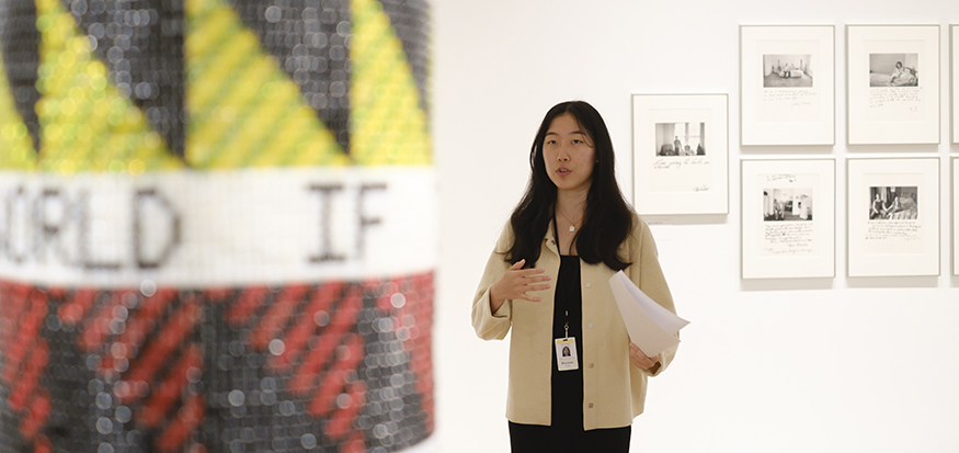 Elizabeth Xiong speaking in front of an artwork at the Seattle Art Museum.
